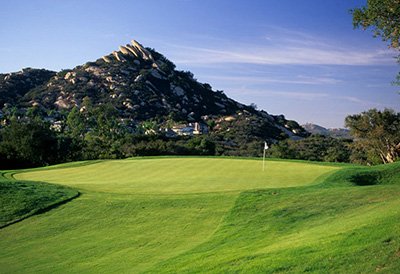 view of elevated green with a mountain in the background